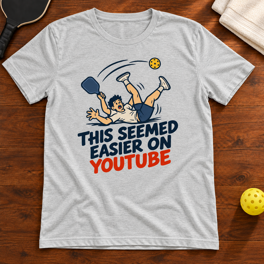 This Seemed Easier on YouTube Pickleball T-Shirt, athletic-heather, warm wood flat lay