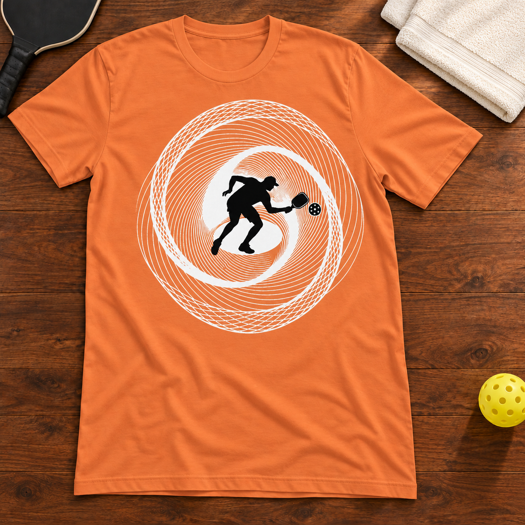 Dink in Motion Pickleball T-Shirt, burnt-orange, warm wood flat lay