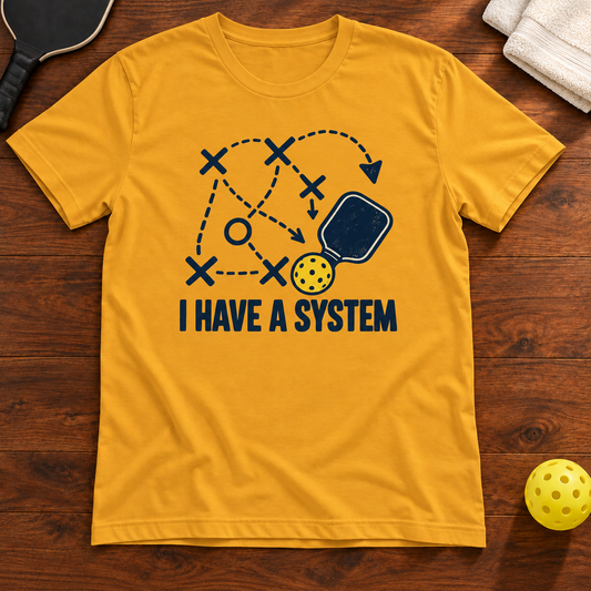 I Have a System Pickleball T-Shirt, mustard, warm wood flat lay