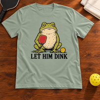 Let Him Dink Frog Pickleball T-Shirt, sage, warm wood flat lay